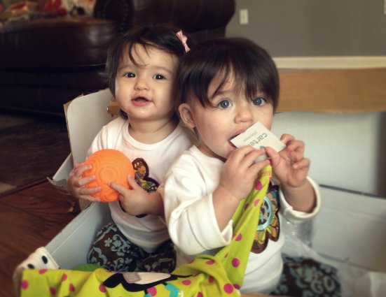 Ava and Kaitlyn sit in the box of goodies we just received from their grandparents.